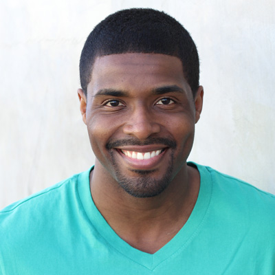 An elderly couple sharing a moment of joy, with the man holding his arm around the woman.